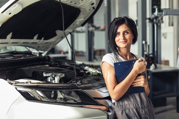 Front view mechanic woman with clipboard