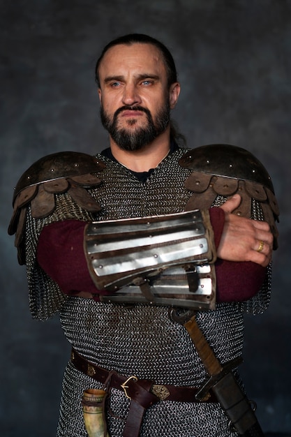 Front view medieval soldier posing in studio