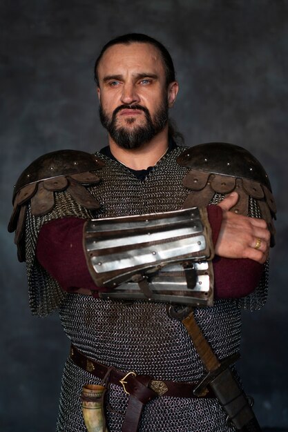 Front view medieval soldier posing in studio