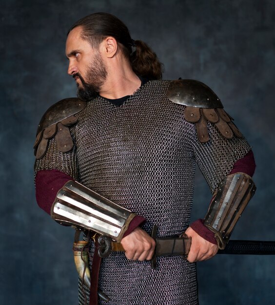 Front view medieval soldier posing in studio