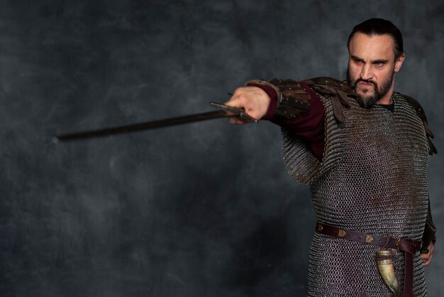 Front view medieval soldier posing in studio