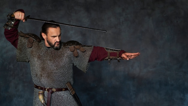 Front view medieval soldier posing in studio