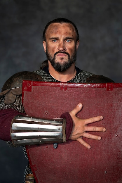 Front view medieval soldier posing in studio