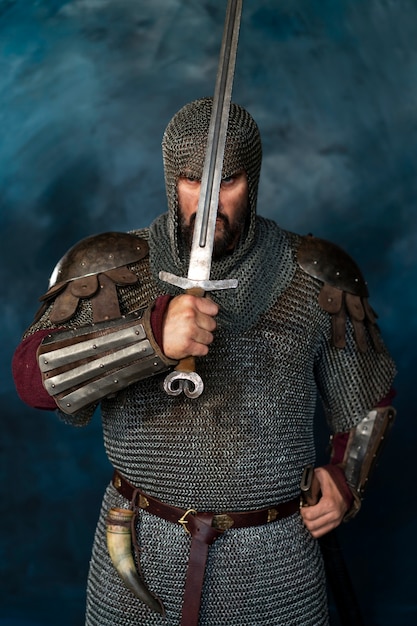 Front view medieval soldier posing in studio