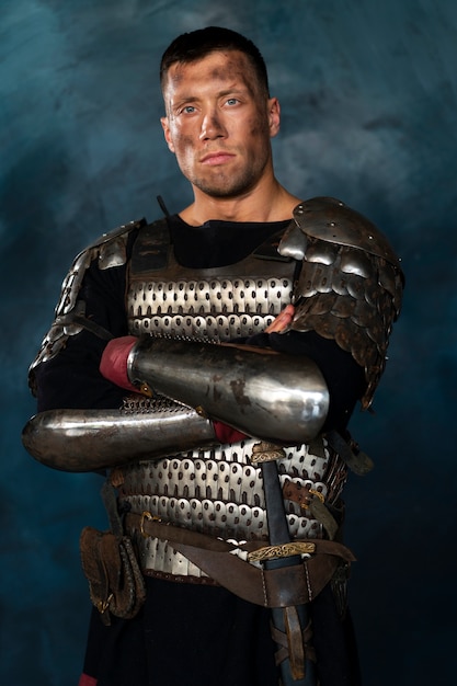 Front view medieval soldier posing in studio