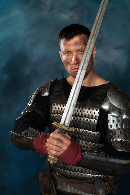 Front view medieval soldier posing in studio