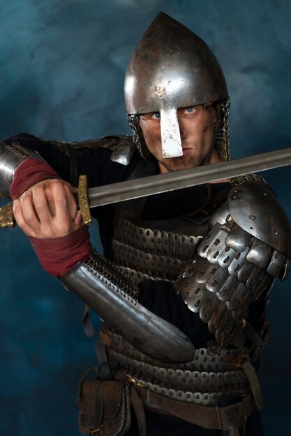 Front view medieval soldier posing in studio