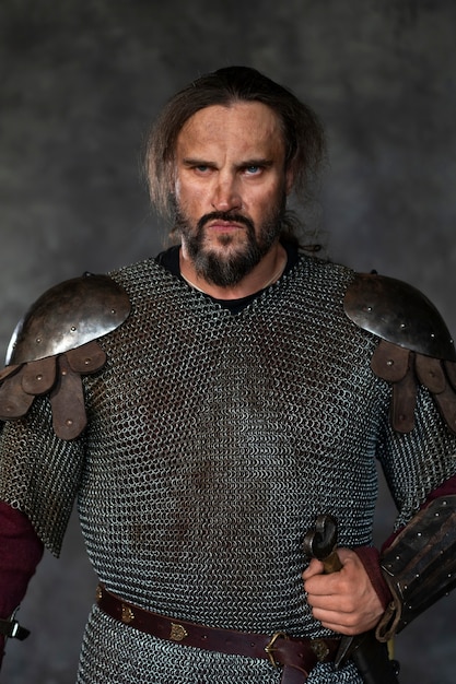 Front view medieval soldier posing in studio