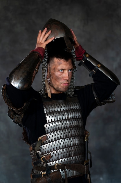 Front view medieval soldier posing in studio