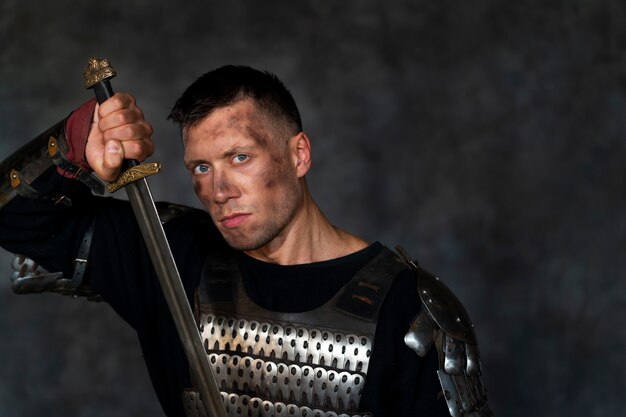 Front view medieval soldier posing in studio