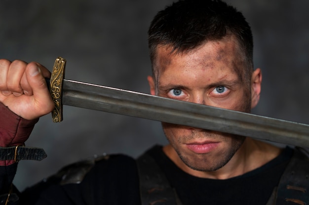 Front view medieval soldier posing in studio