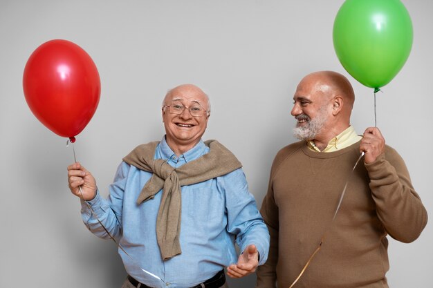Front view men holding balloons