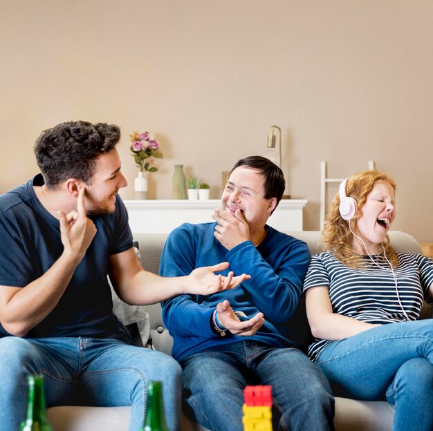 Front view of men laughing at woman singing