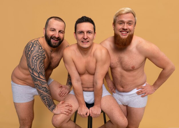 Front view men posing together in studio