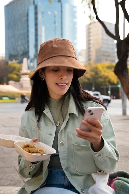 Front view mexican woman eating ranchero food