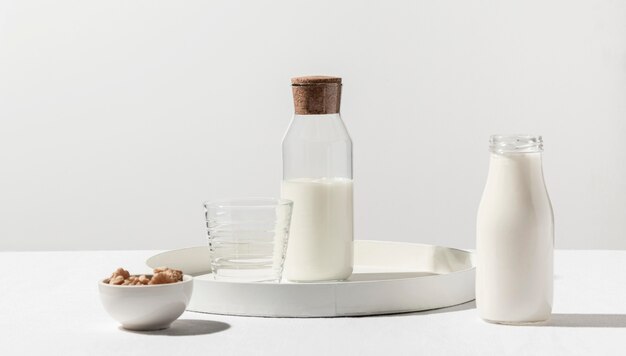 Front view of milk bottle with walnuts on tray