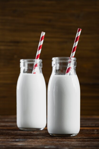 Front view milk bottles with straws