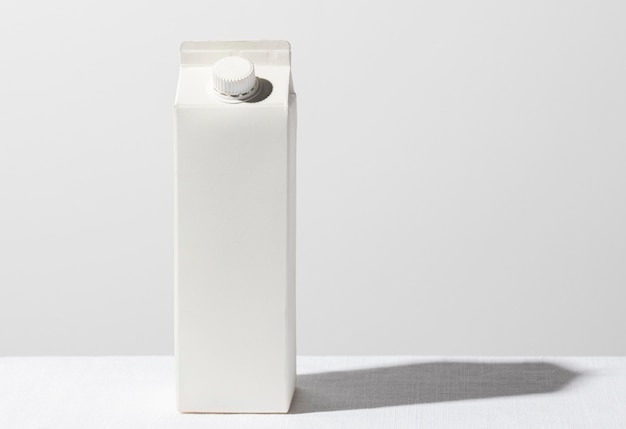 Front view of milk carton with copy space