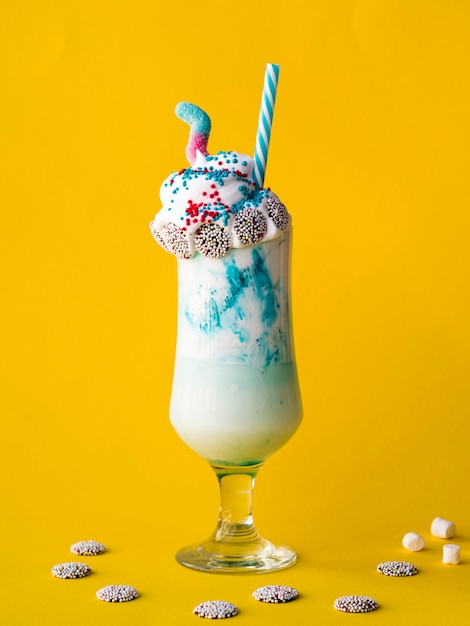 Front view of milkshake on yellow background