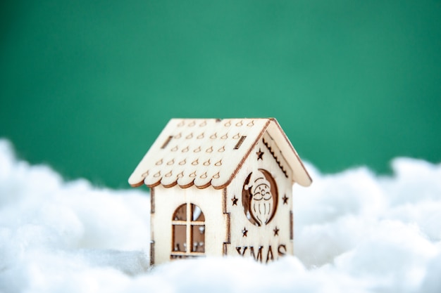 Free photo front view mini wood house on green background