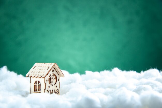 Front view mini wood house on green background