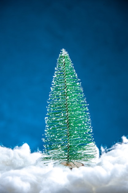 Front view mini xmas tree on blue white background