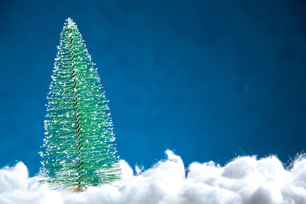 Front view mini xmas tree on blue white background