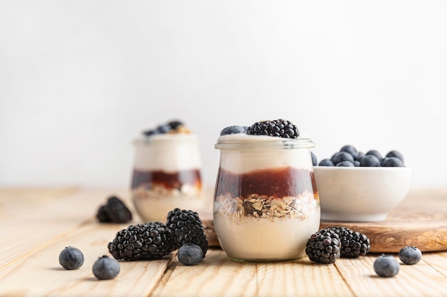 Front view mix of yogurt with berries, oats and jam