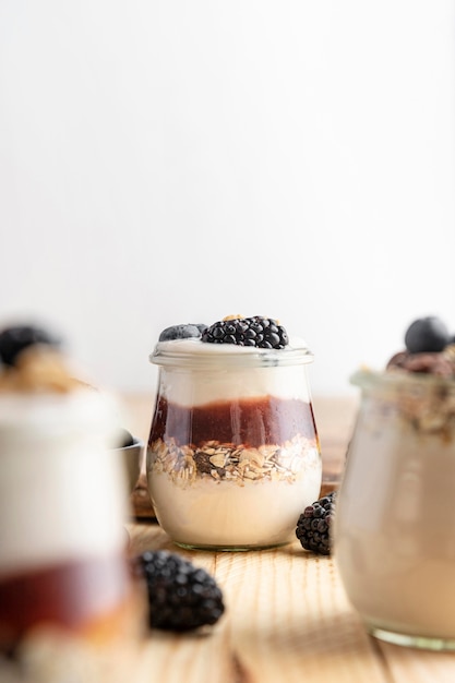 Front view mix of yogurt with blackberries, jam and oats