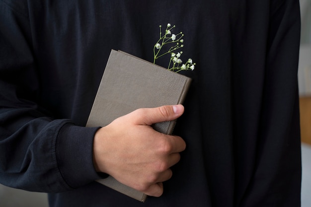 Front view model holding book with flowers