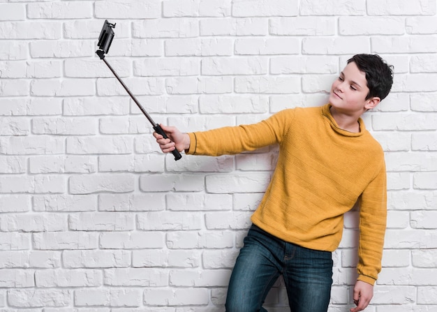 Free photo front view of modern boy taking a selfie