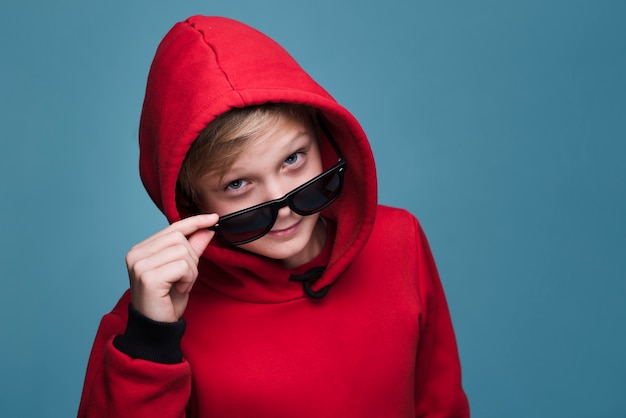 Free photo front view of modern boy with sunglasses posing