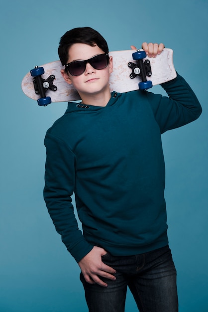 Front view of modern boy with sunglasses posing