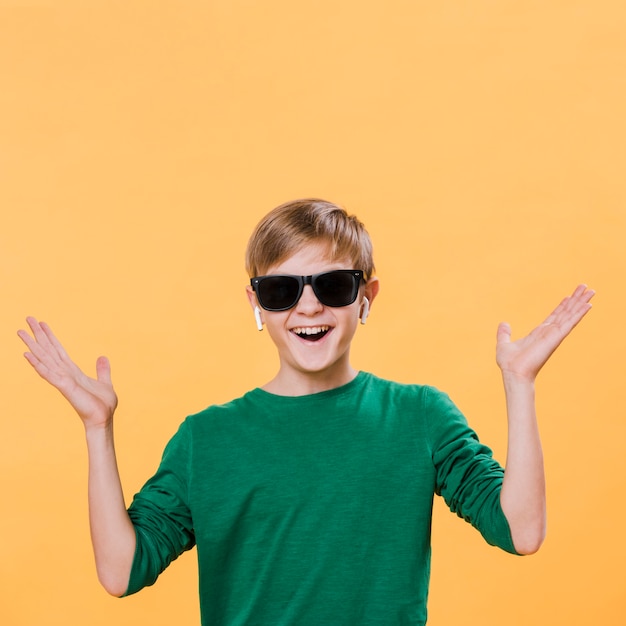 Free photo front view of modern boy with sunglasses