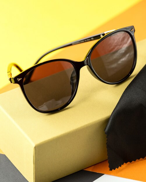 A front view modern dark sunglasses on the orange-black