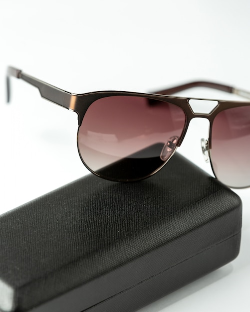 A front view modern dark sunglasses on the white