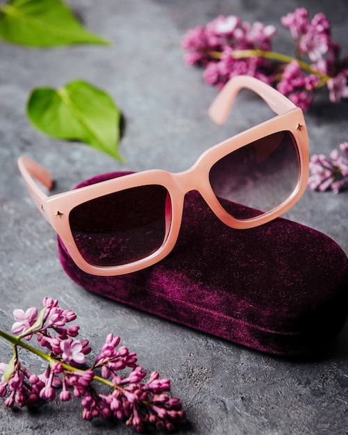 A front view modern pink sunglasses on the grey