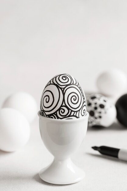 Front view of monochrome egg for easter in egg cup with copy space