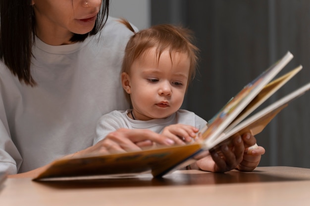 front view mother and baby with book
