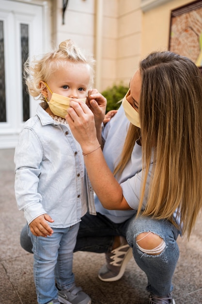 Front view of mother and child with medical masks