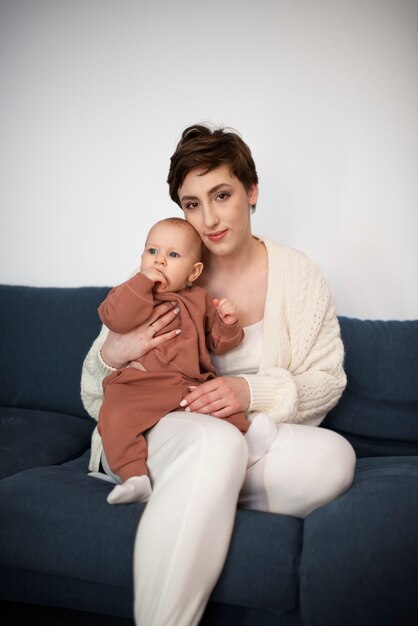 Front view mother on couch with baby