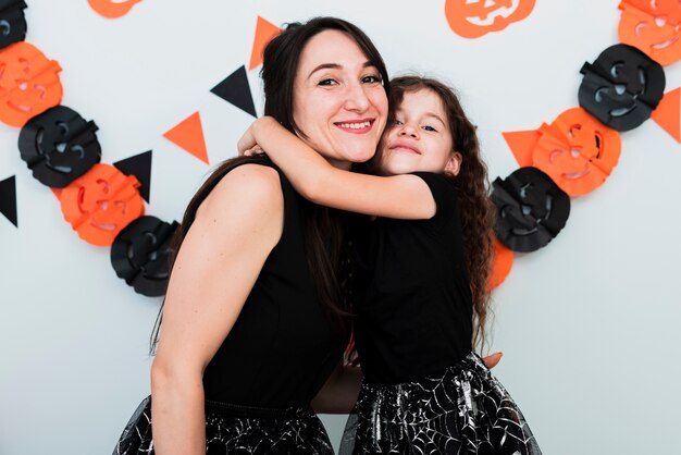 Front view of mother and daughter looking at camera