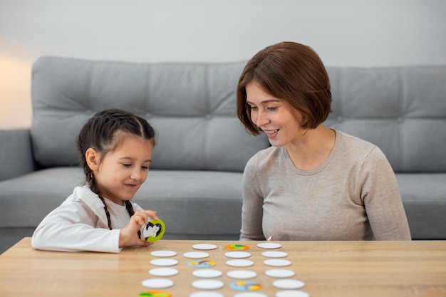 Front view mother and girl playing game