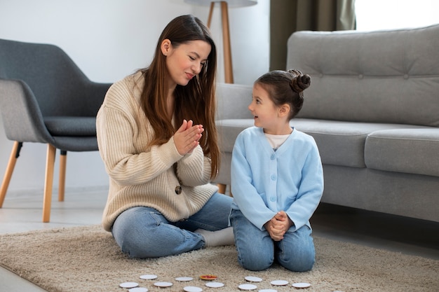 Free photo front view mother and girl playing game