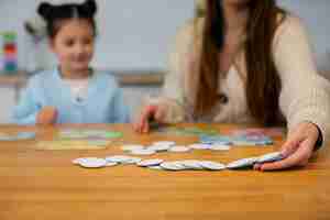 Free photo front view mother and girl playing game