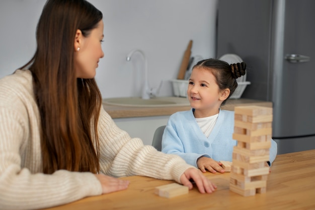 Free photo front view mother and girl playing game