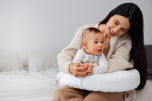 Free photo front view mother holding newborn baby