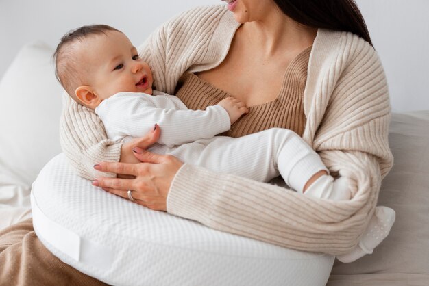 Front view mother holding newborn baby