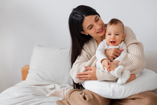 Front view mother holding newborn baby