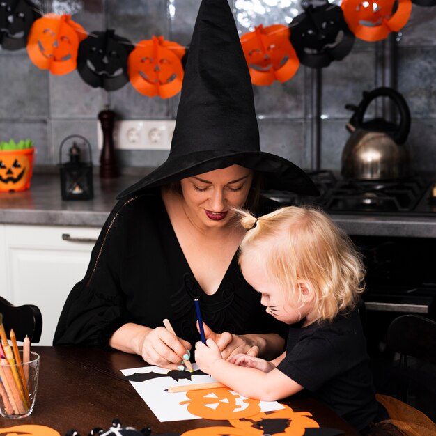 Front view of mother and kid with halloween elements